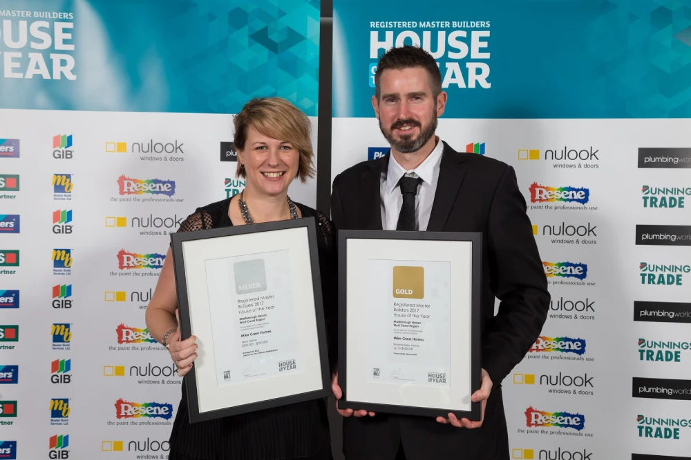 a man and woman holding up framed certificates