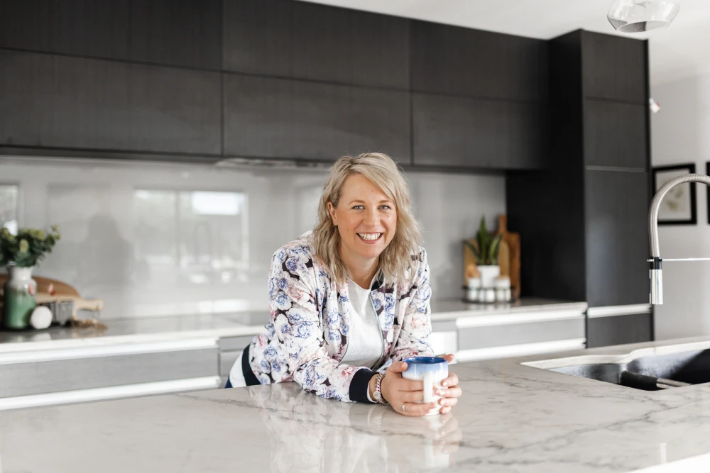 a woman sitting at a counter with a mug