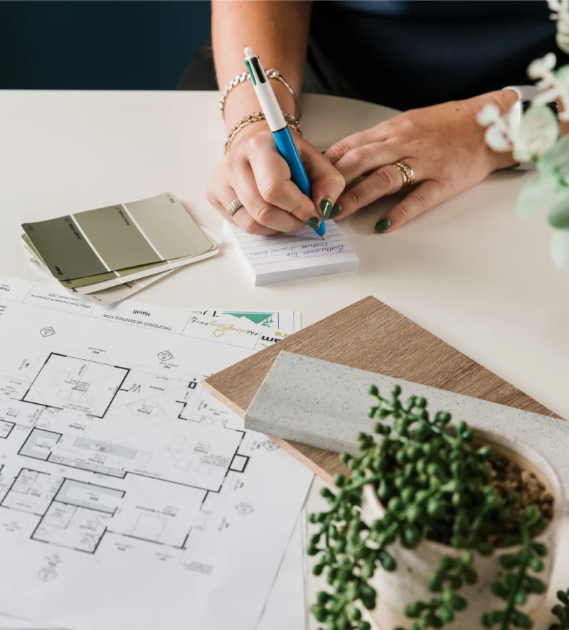 an interior designer writing on a notepad