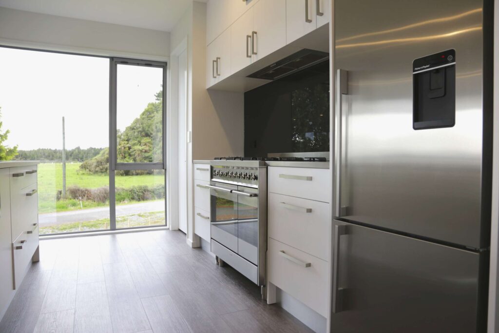 a kitchen with a large glass door